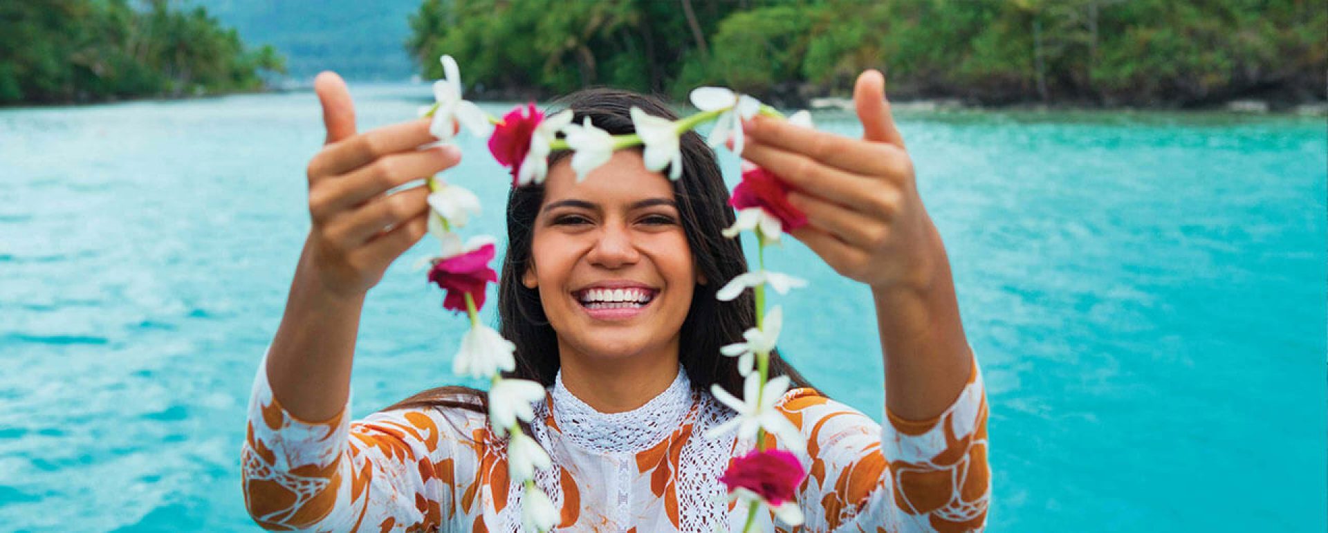 tahitian woman holding lei