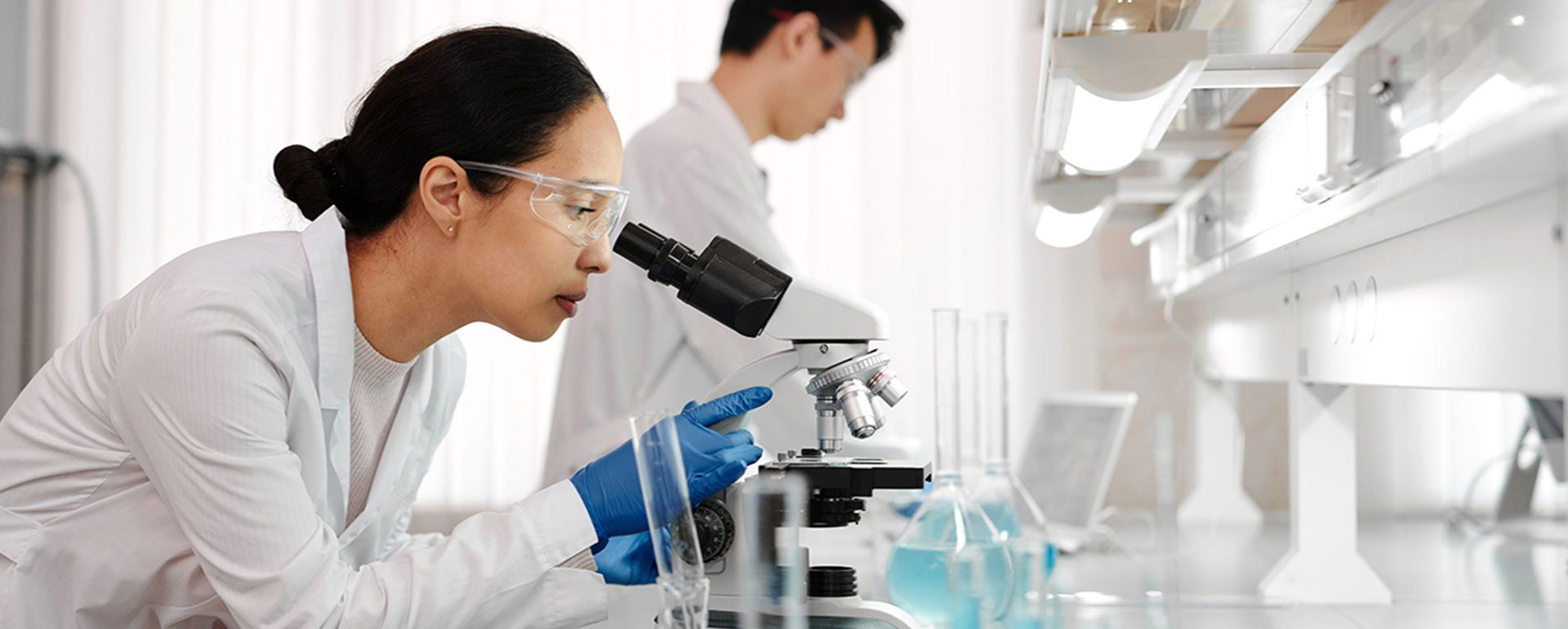 female scientist using a microscope in a lab