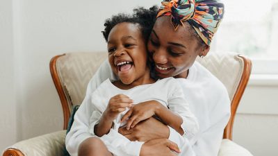 african american mother holding child