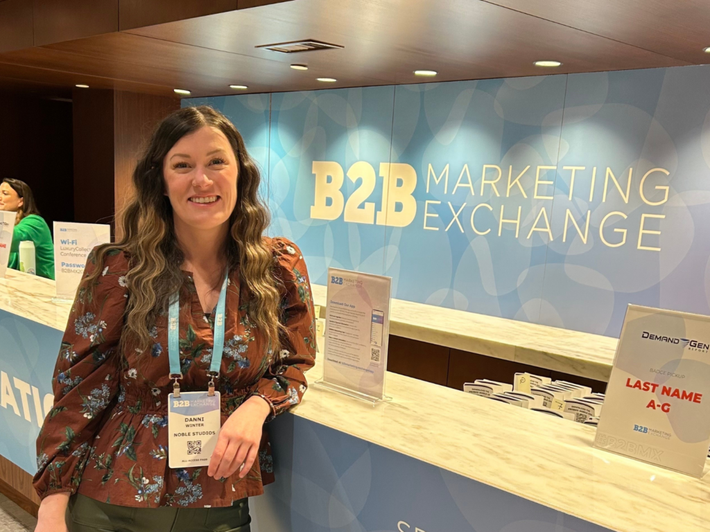 Director of Integrated Planning and Paid Media Danni Winter from Noble Studios at the 2025 B2B Marketing Exchange registration desk in Scottsdale