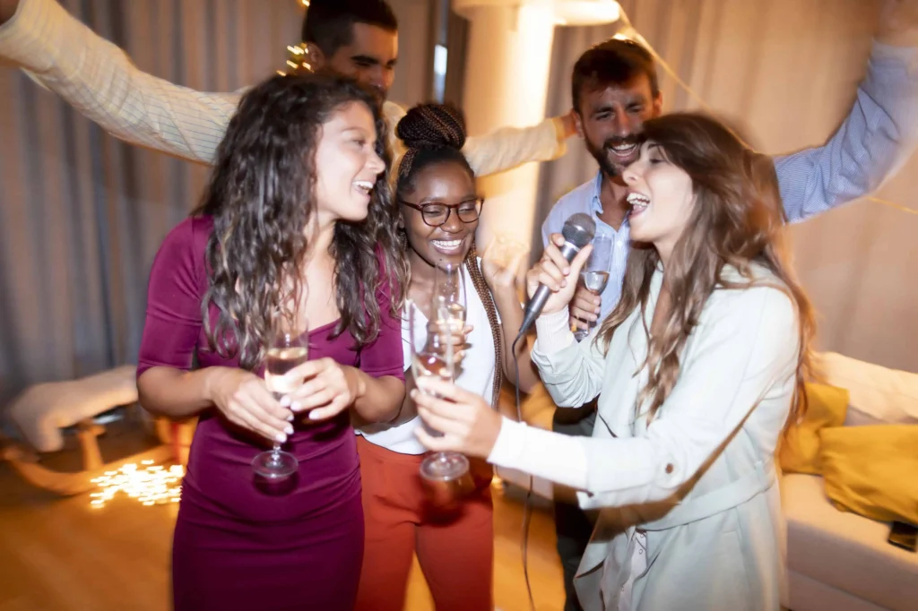 Group of friends singing karaoke, symbolizing success in organic lead generation and building relationships.