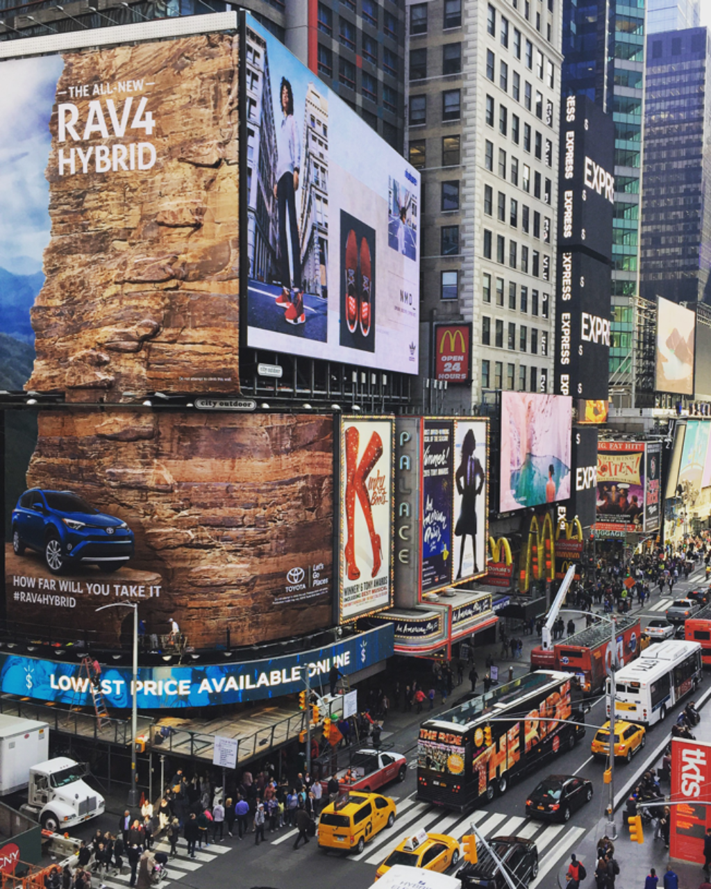 Toyota RAV4 marketing activation featuring professional climbers scaling a 100-foot tall rock climbing wall billboard in Times Square, New York City, bringing the 'How Far Will You Take It' campaign to life